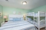 Guest room with comfortable king bed and twin bunk, smart tv